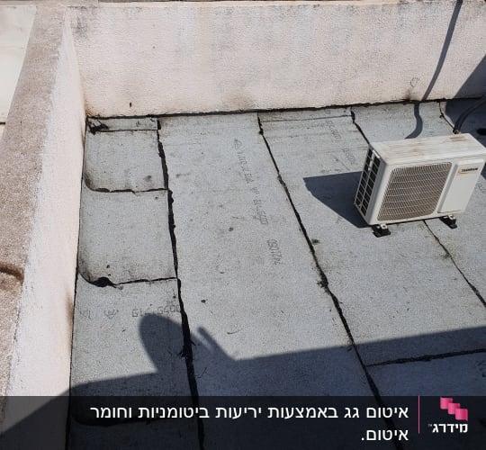 Roof with sealing material and air conditioning unit